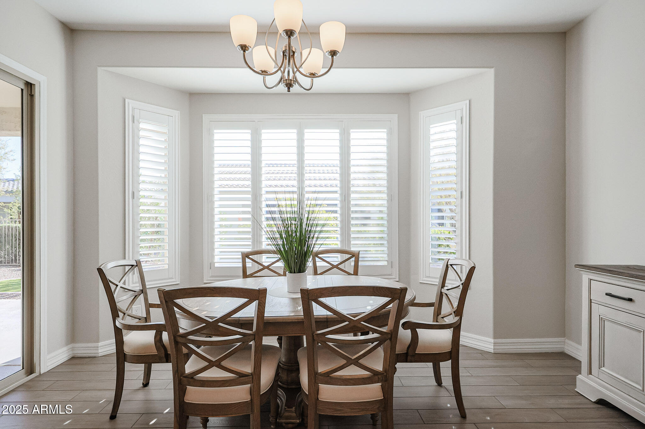 17885 West Ashurst Drive Goodyear, AZ 85338 - Photo 12 of 63 a view of a dining room with furniture wooden floor and chandelier