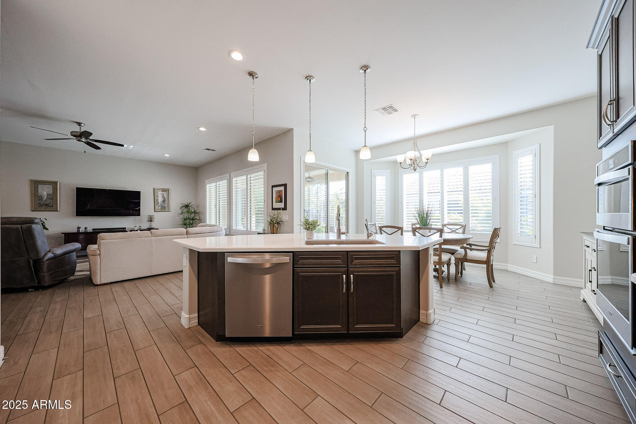 17885 West Ashurst Drive Goodyear, AZ 85338 - Photo 13 of 63 a large kitchen with stainless steel appliances a large counter top a sink a stove and a refrigerator