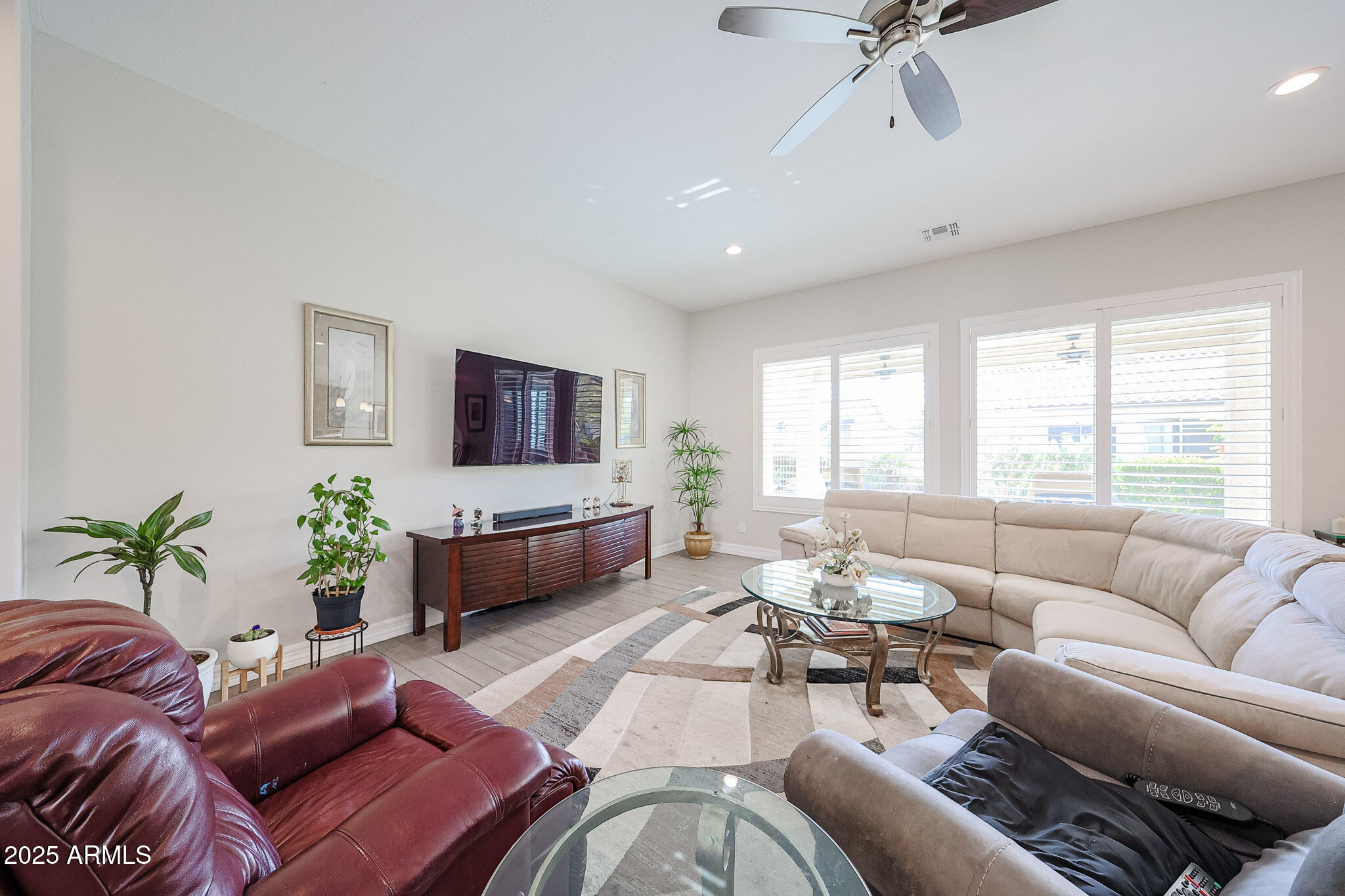 17885 West Ashurst Drive Goodyear, AZ 85338 - Photo 15 of 63 a living room with furniture and a flat screen tv
