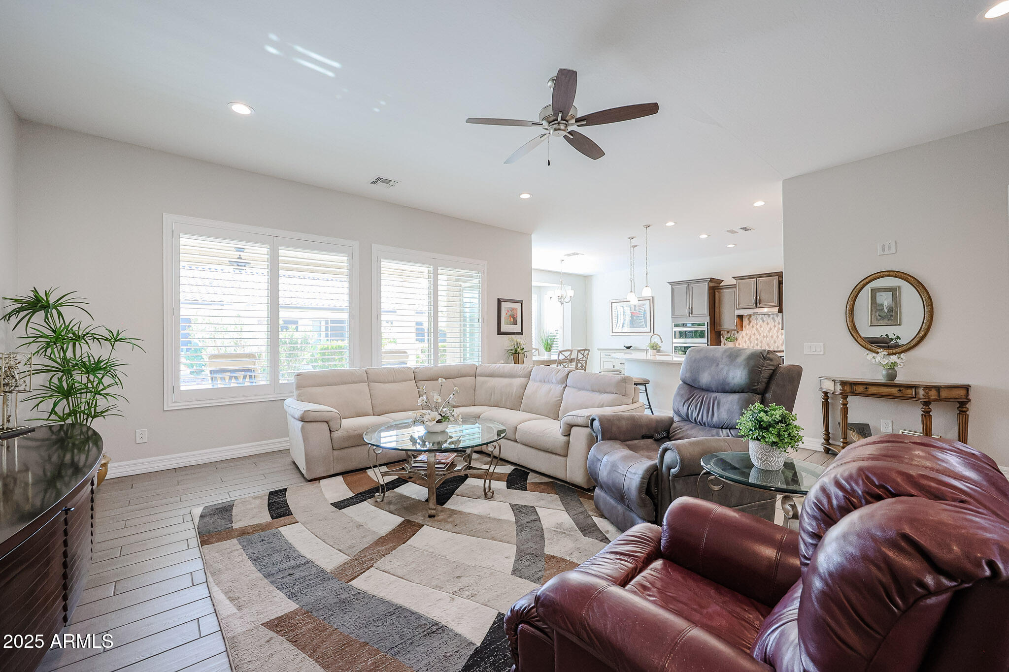 17885 West Ashurst Drive Goodyear, AZ 85338 - Photo 16 of 63 a living room with furniture ceiling fan and a window