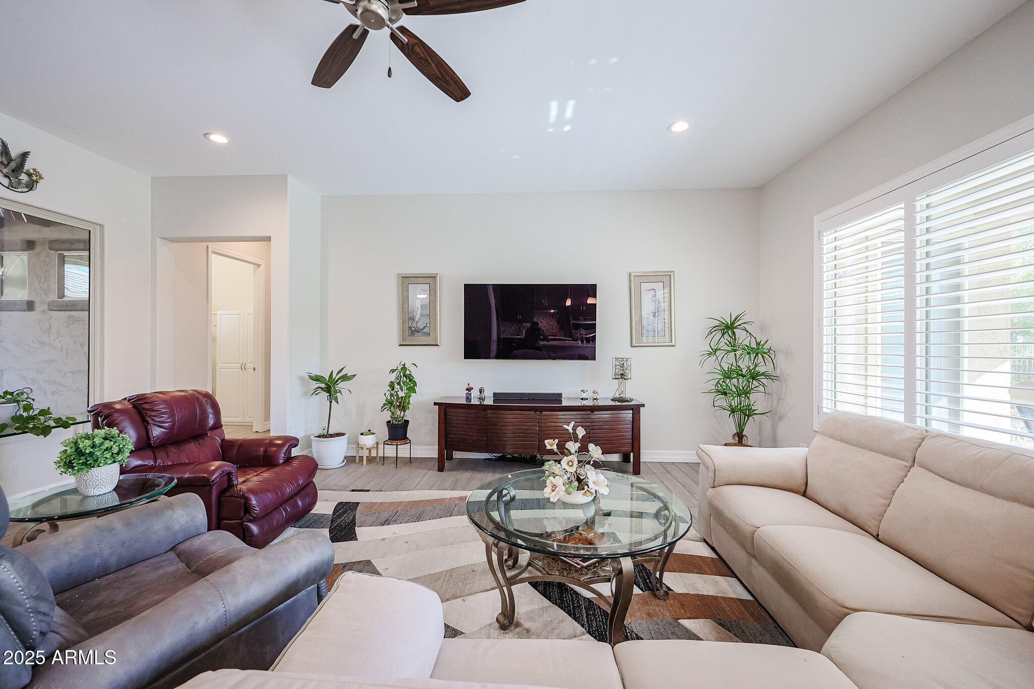 17885 West Ashurst Drive Goodyear, AZ 85338 - Photo 17 of 63 a living room with furniture and a flat screen tv