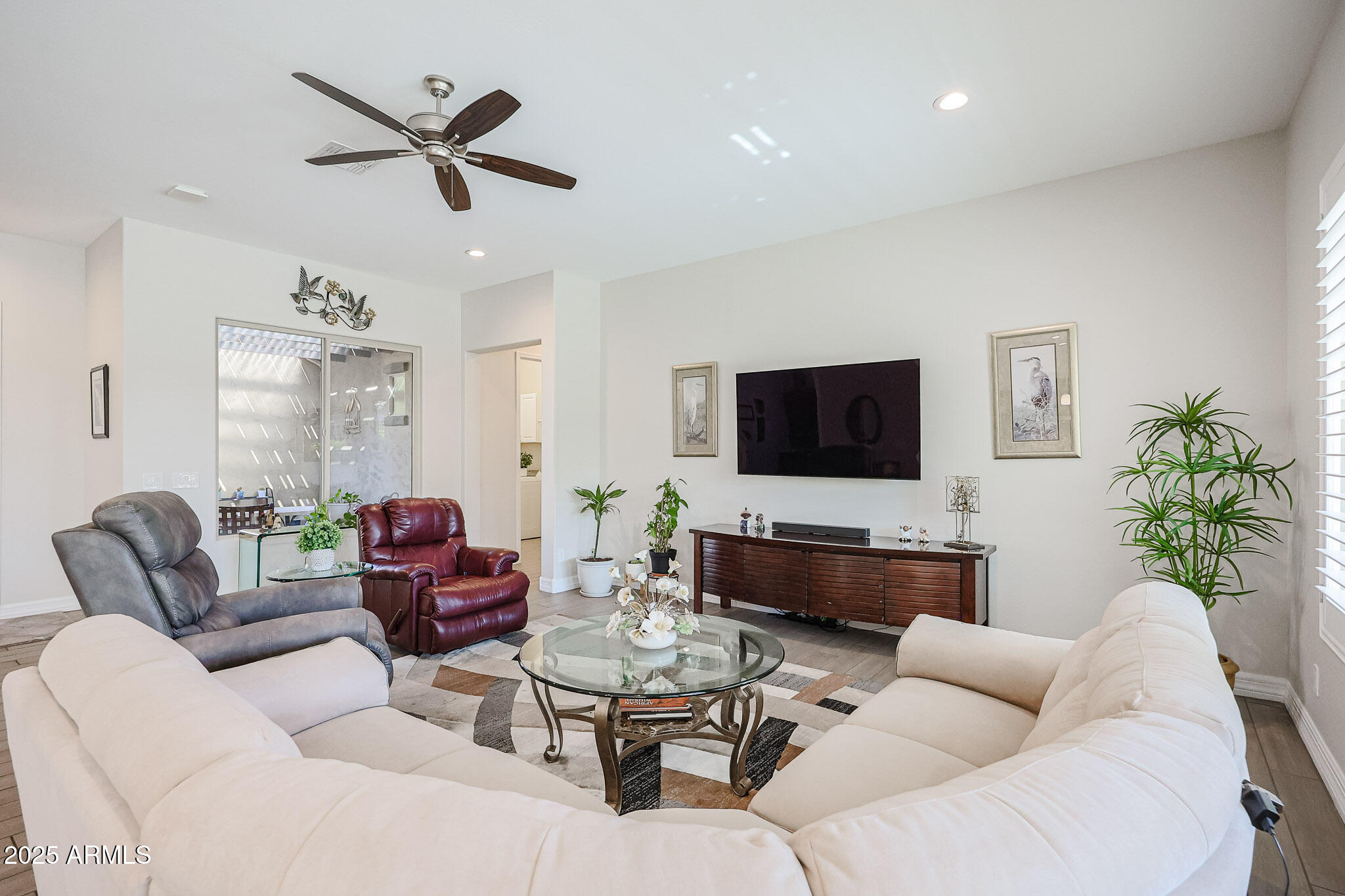 17885 West Ashurst Drive Goodyear, AZ 85338 - Photo 18 of 63 a living room with furniture and a flat screen tv