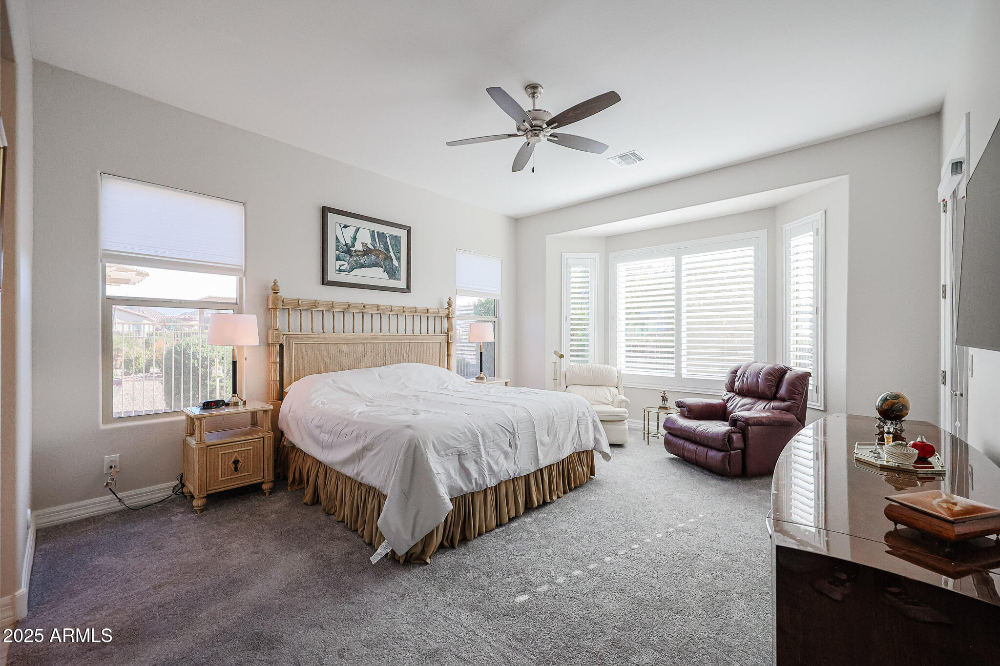 17885 West Ashurst Drive Goodyear, AZ 85338 - Photo 20 of 63 a spacious bedroom with a bed and a couch
