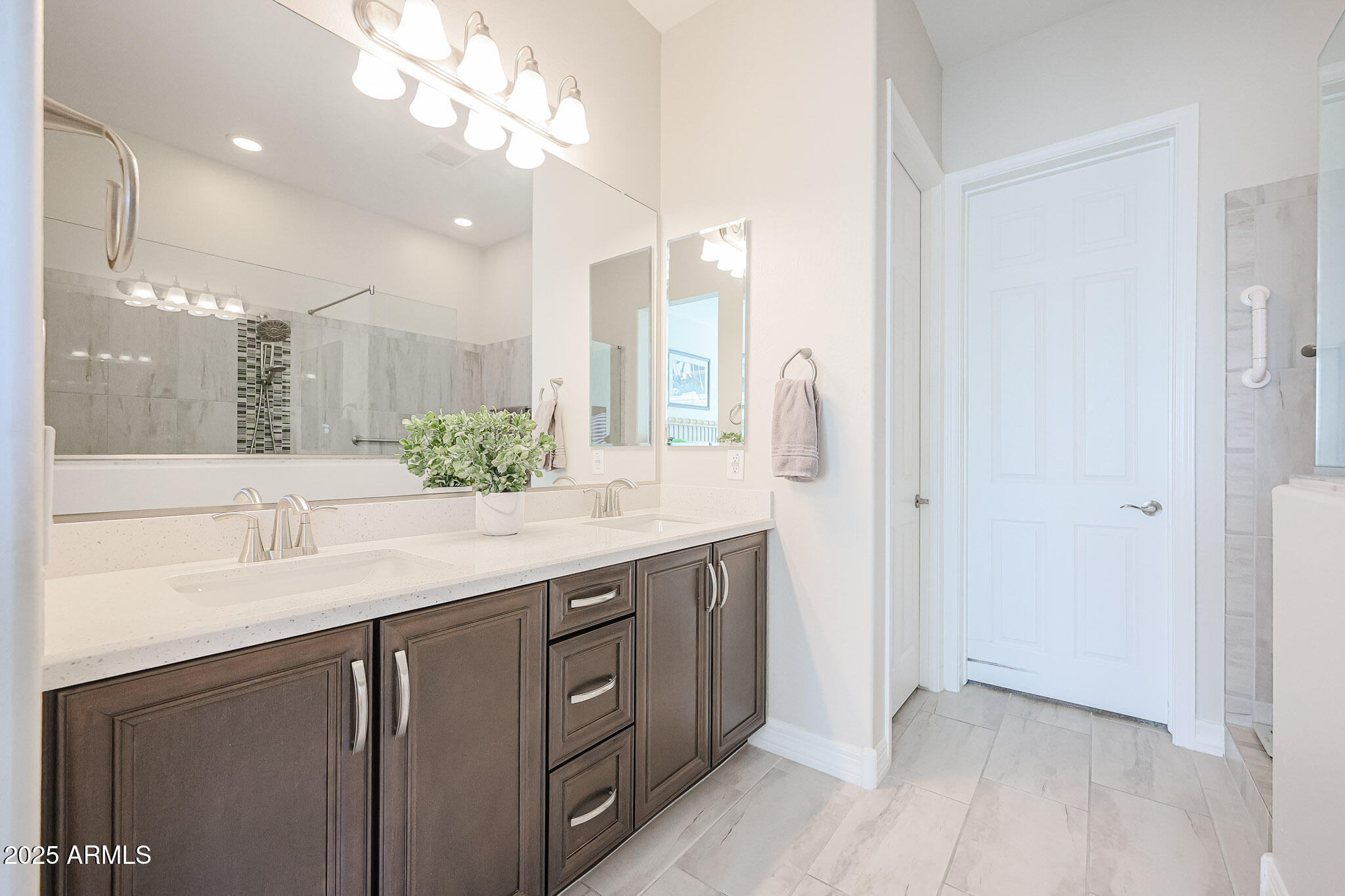 17885 West Ashurst Drive Goodyear, AZ 85338 - Photo 23 of 63 a bathroom with a double vanity sink and a mirror