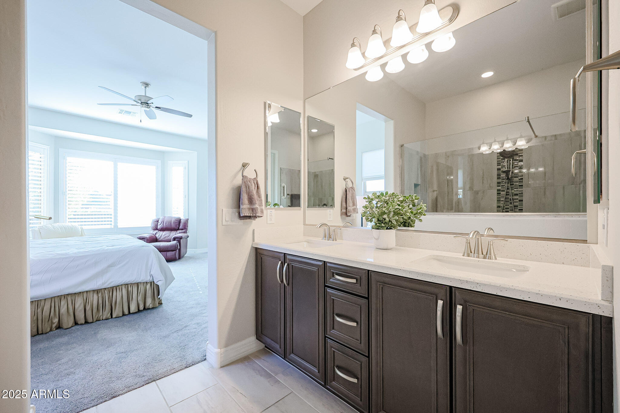 17885 West Ashurst Drive Goodyear, AZ 85338 - Photo 24 of 63 a spacious bathroom with a double vanity sink a mirror and a shower
