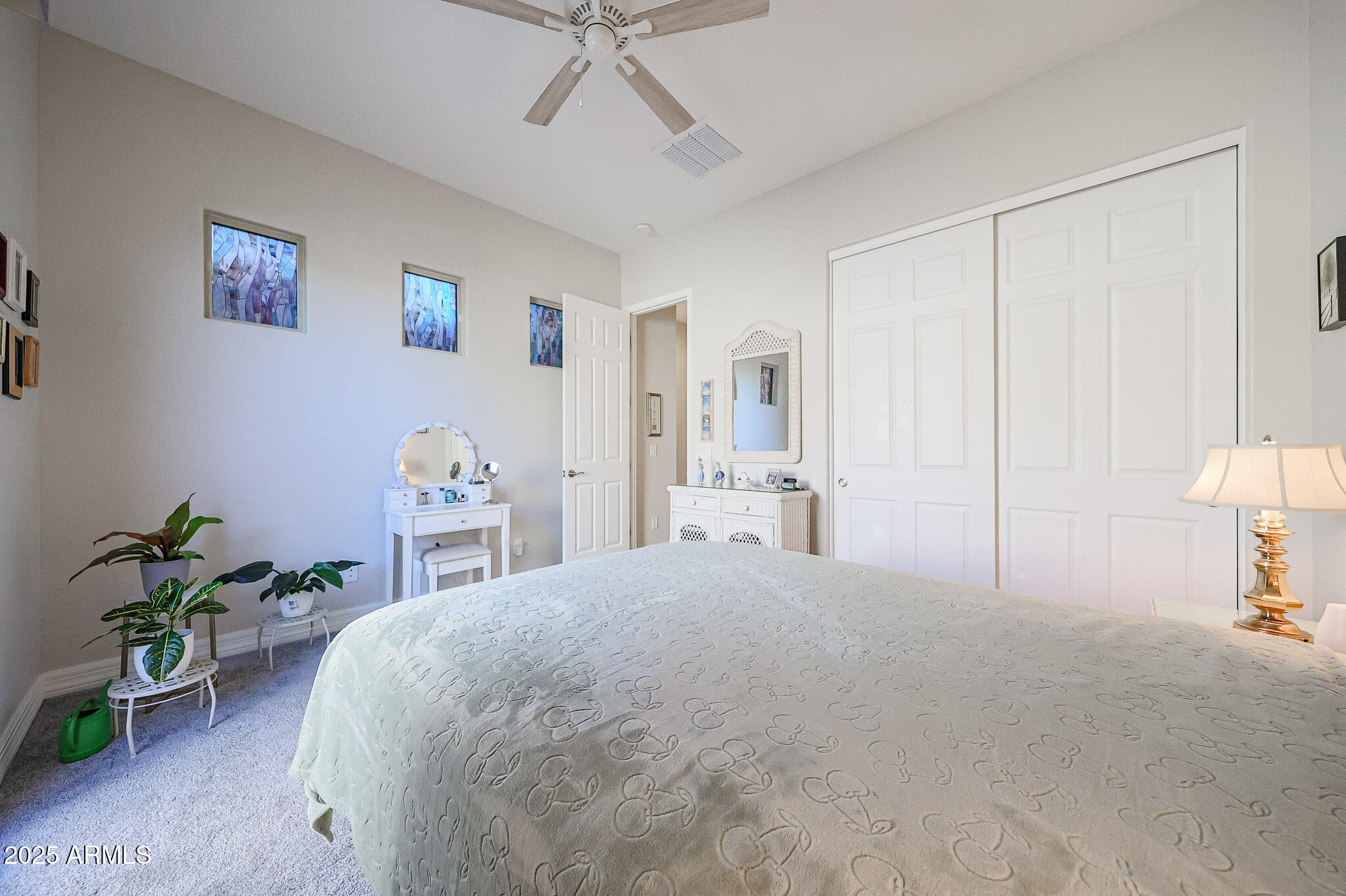 17885 West Ashurst Drive Goodyear, AZ 85338 - Photo 29 of 63 a spacious bedroom with a bed and a table