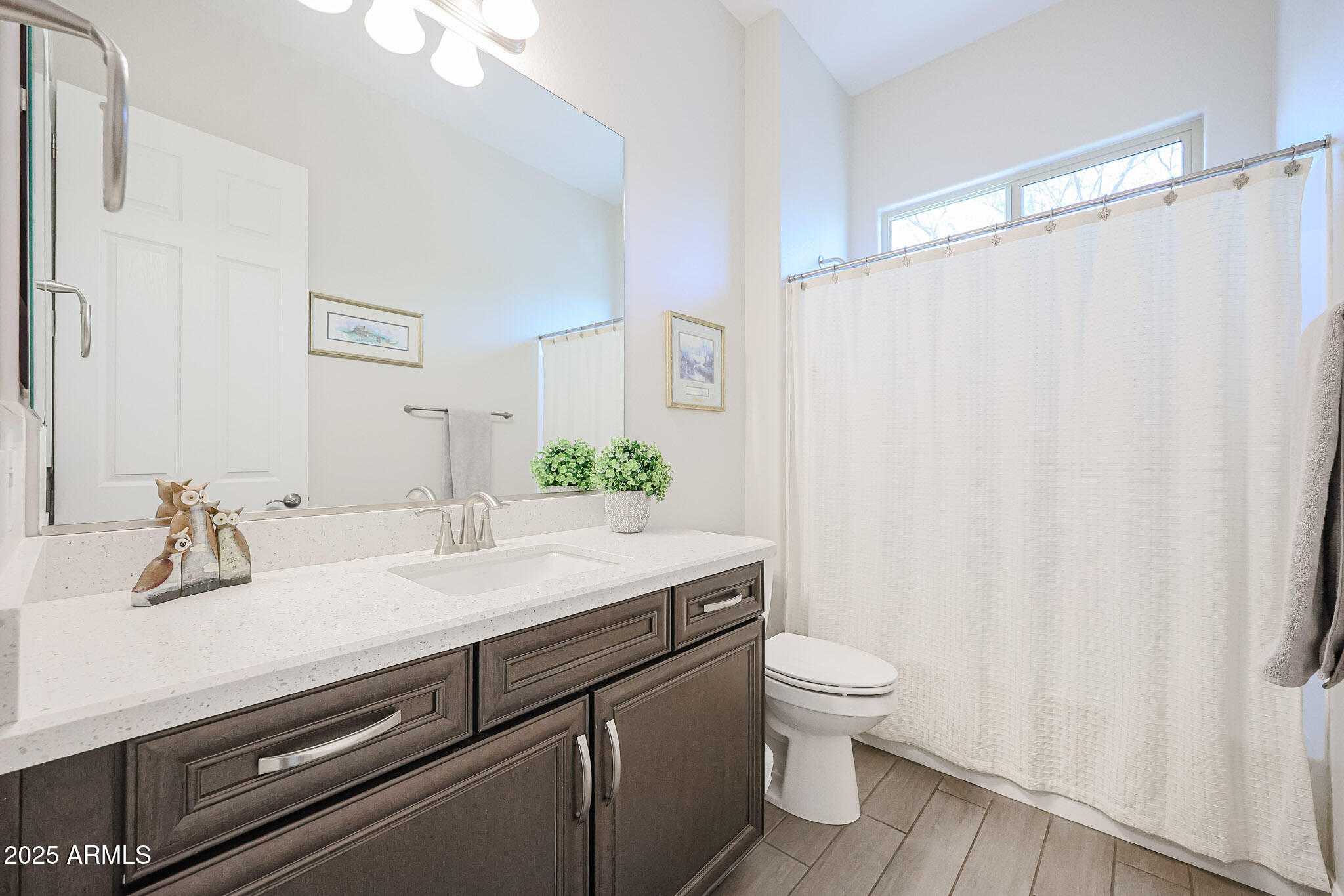 17885 West Ashurst Drive Goodyear, AZ 85338 - Photo 30 of 63 a bathroom with a granite countertop sink and a mirror