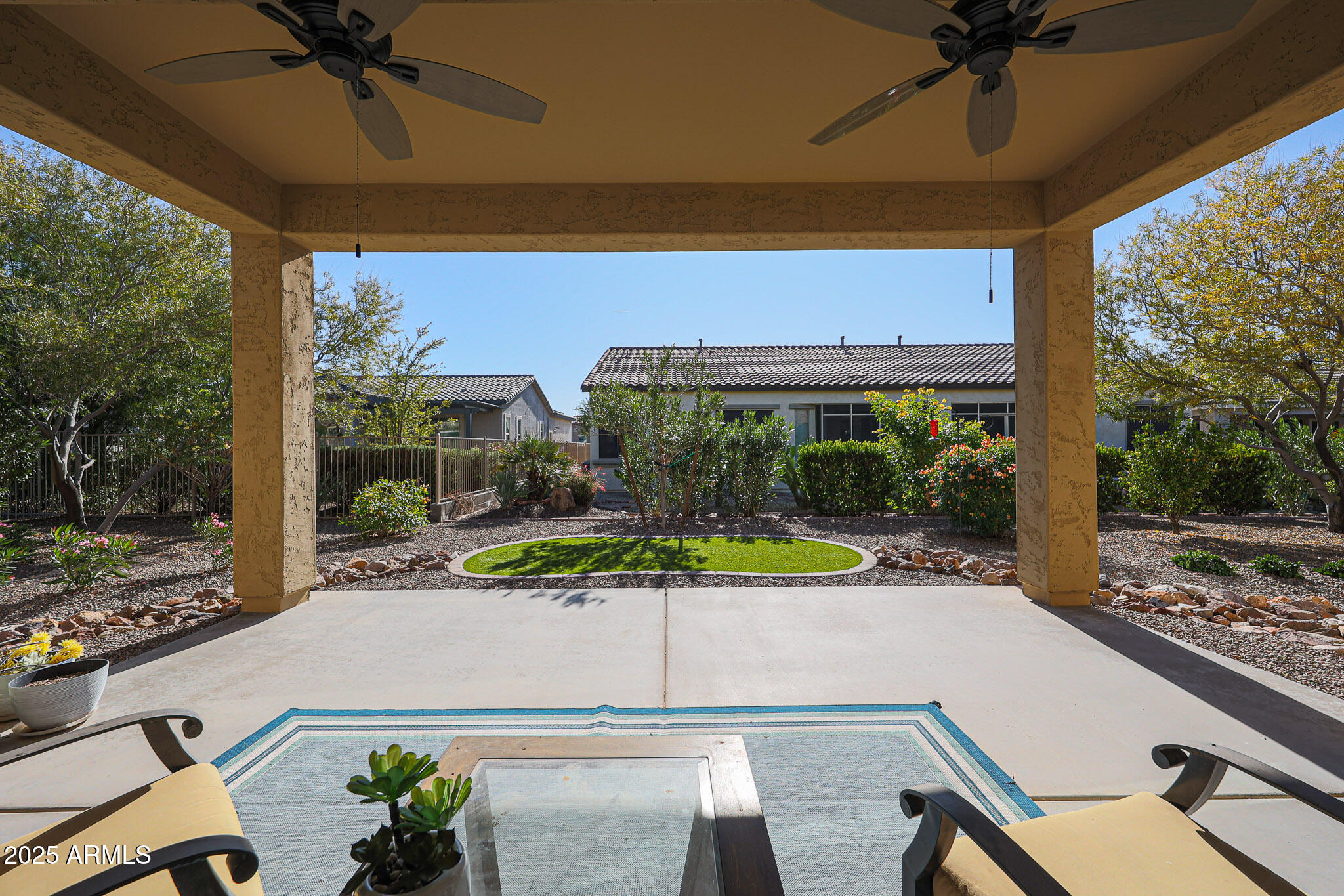 17885 West Ashurst Drive Goodyear, AZ 85338 - Photo 34 of 63 a view of a patio with table and chairs under an umbrella