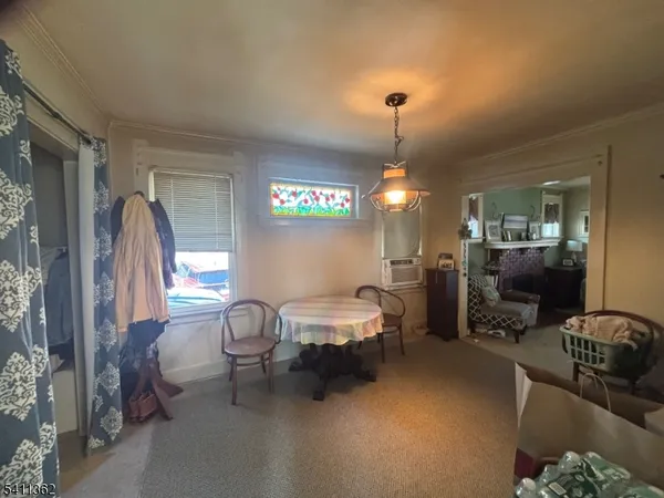 a living room with furniture a chandelier and a window