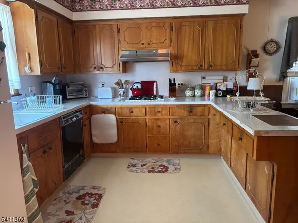a kitchen with stainless steel appliances granite countertop a stove sink and cabinets