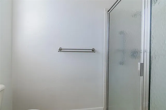 a bathroom with a glass shower door