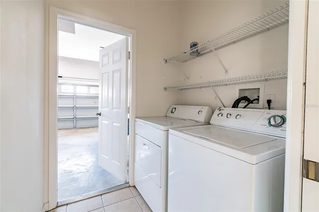 a utility room with cabinets washer and dryer