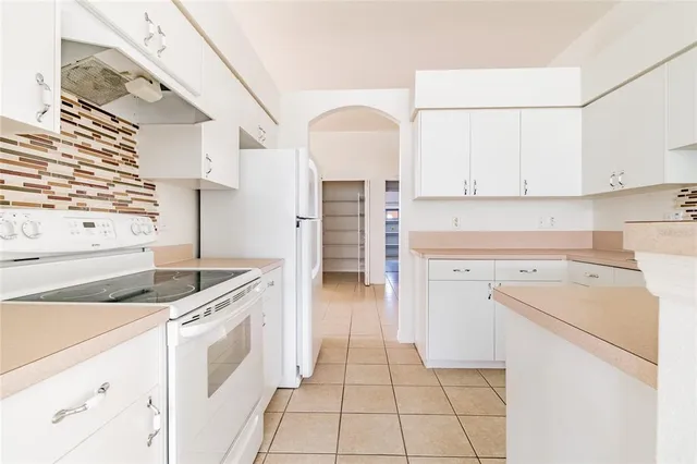 a kitchen with a stove cabinets and a sink