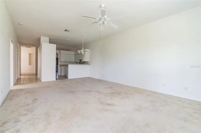 a view of a kitchen with a sink and a refrigerator