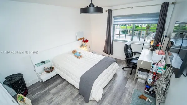 a bedroom with a bed and a large window