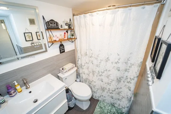 a bathroom with a sink toilet and shower