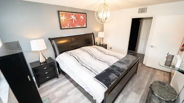 a bedroom with a bed and a mirror