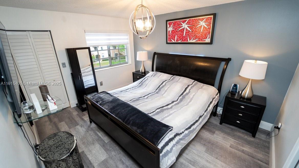 The Enclave at Miramar Miramar, FL 33025 - Photo 18 of 23 a bedroom with a bed and a flat screen tv