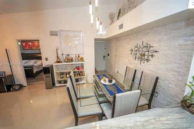 a dining room with furniture and a chandelier