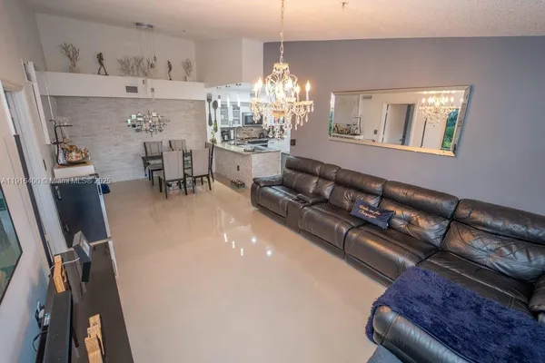 a living room with furniture and a chandelier