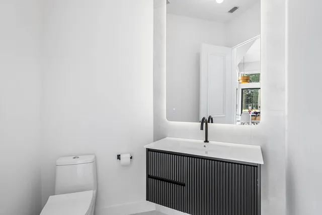 a bathroom with a tub a sink and mirror
