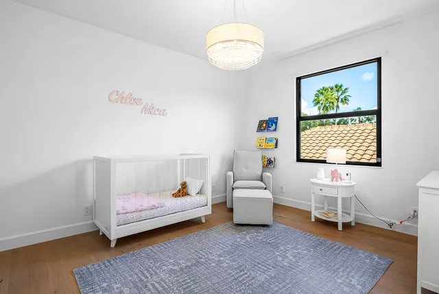 a bedroom with a bed and a night stand