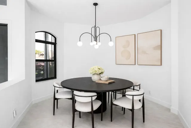 a kitchen that has a lot of cabinets in it and wooden floor