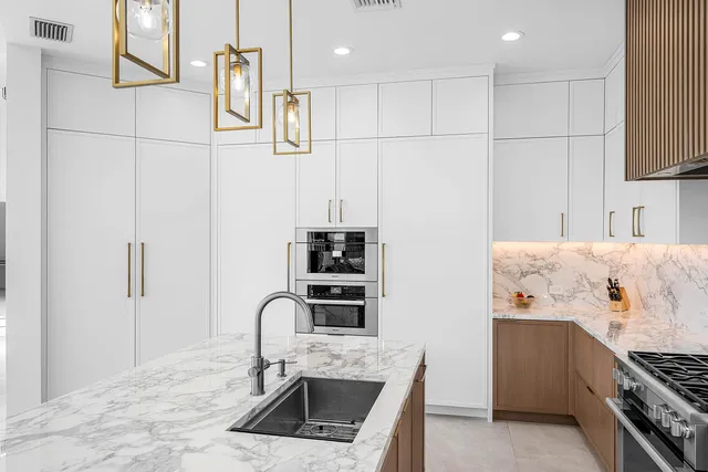 a kitchen with stainless steel appliances a sink and cabinets