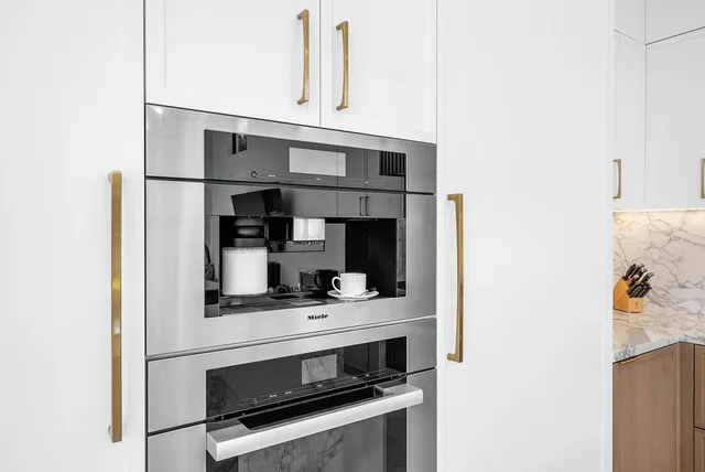 a living room with furniture a flat screen tv and a floor to ceiling window