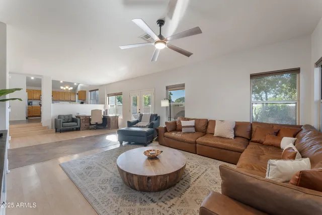 a living room with furniture a rug and a window