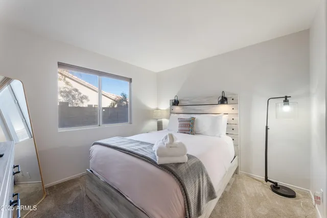 a bedroom with a bed and a window