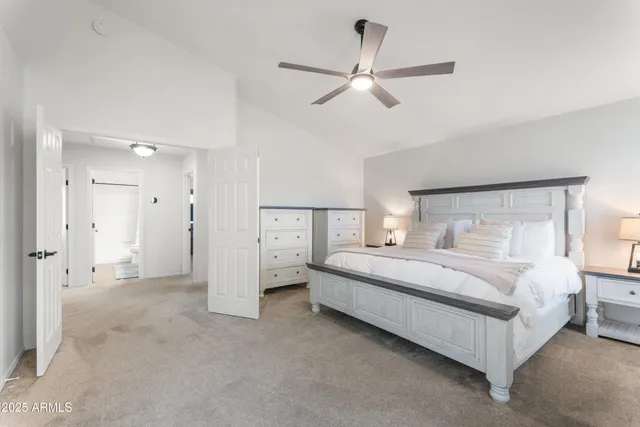 a bedroom with a bed and a ceiling fan