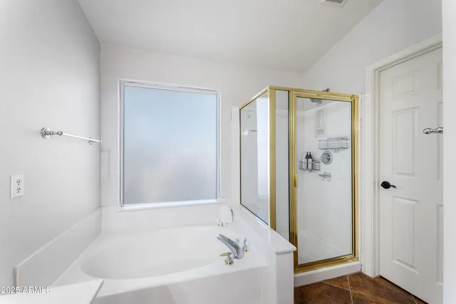 a bathroom with a bathtub and shower