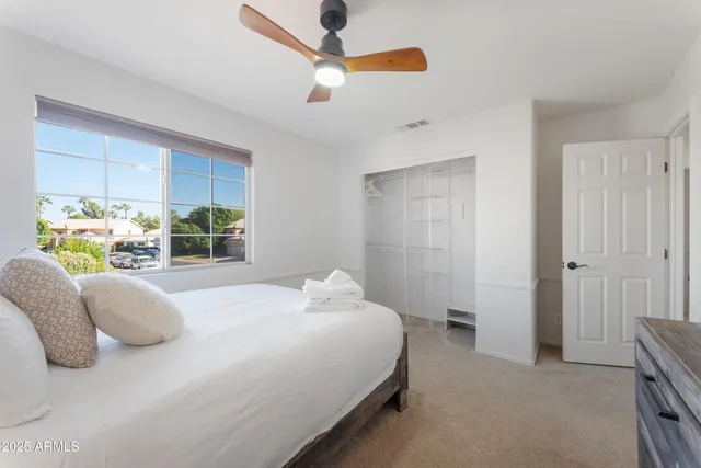 a bedroom with a bed couch and window