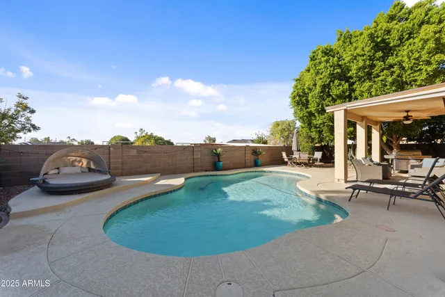 a view of a backyard with table and chairs