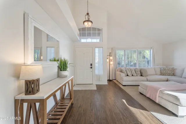 a living room with furniture a lamp and a window
