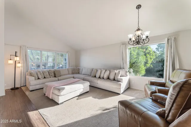 a living room with furniture and a chandelier