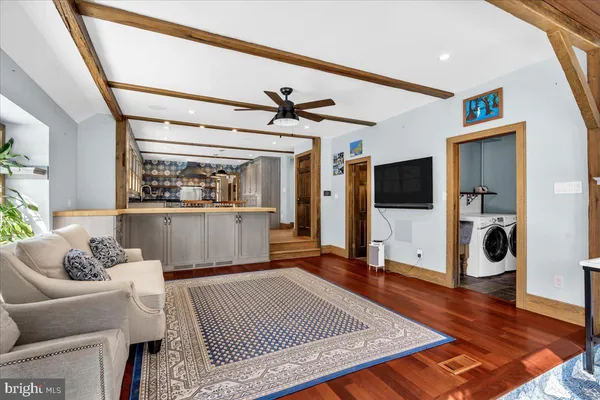 a living room with furniture and wooden floor
