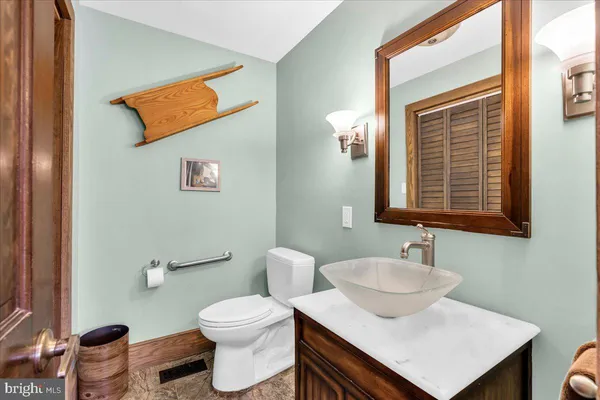 a bathroom with a toilet sink and mirror