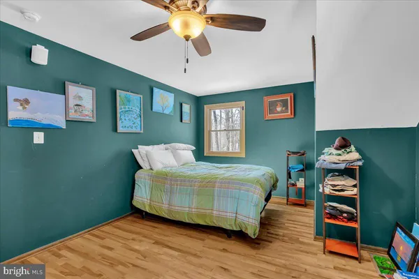 a bedroom with a bed and a bookshelf