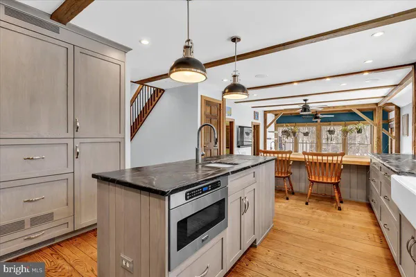 a kitchen with a sink and a stove top oven