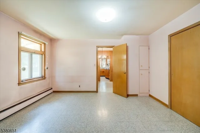 an empty room with windows and closet