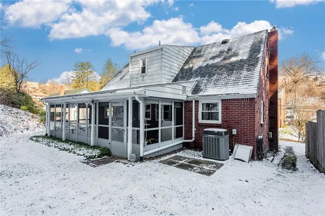 a view of a large building with a bench in front of house