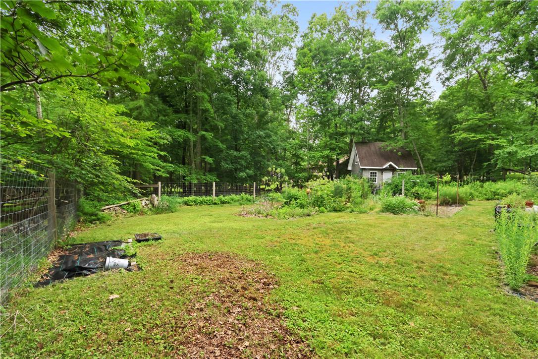209 Remington Road East Stroudsburg, PA 18301 - Photo 33 of 41 A tranquil yard with mature trees and a charming shed offers a private retreat.