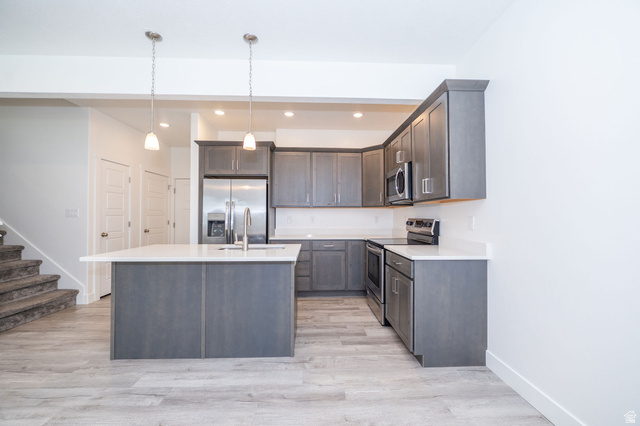 46 West 460 Smithfield, UT 84335 - Photo 8 of 31 Kitchen featuring gray cabinetry, stainless steel appliances, white countertops, and a central island with an undermount sink