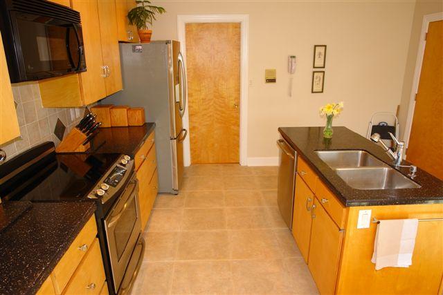 5212 Falcon Ridge Road Roanoke, VA 24018 - Photo 7 of 10 a kitchen with granite countertop a sink stove and cabinets