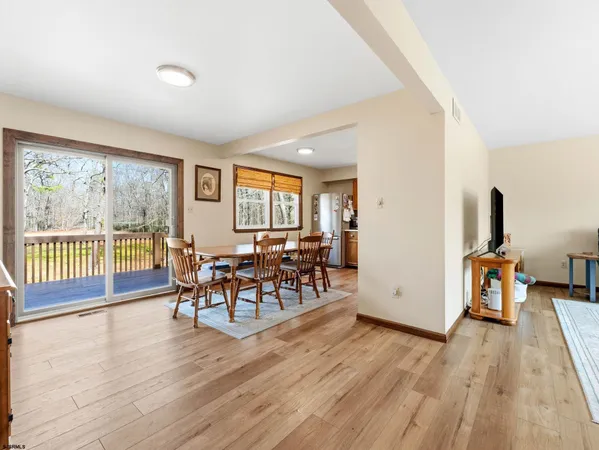 a kitchen with a table chairs refrigerator and cabinets