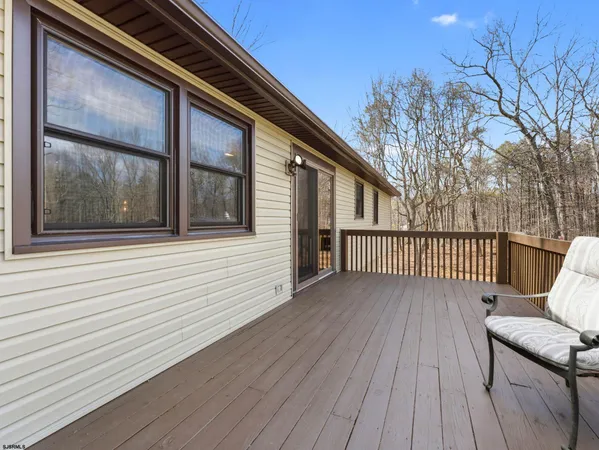 a view of a porch with wooden floor and fence