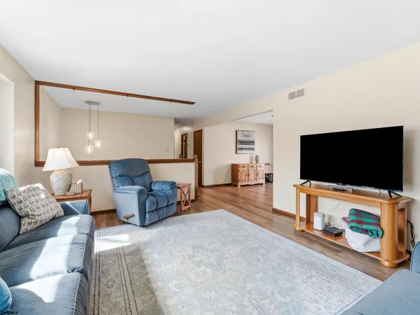 a view of a livingroom with furniture and hardwood floor