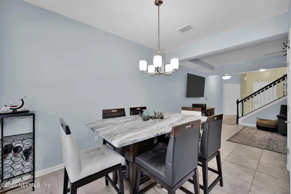 a large kitchen with a table and chairs